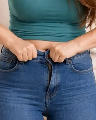 Woman adjusting jeans