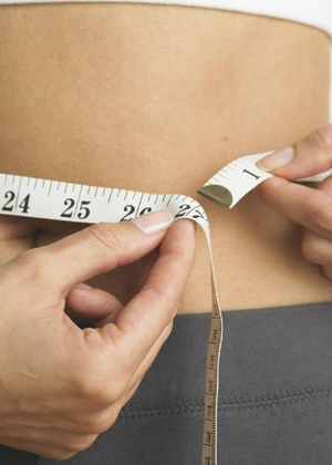 Measuring waist with tape